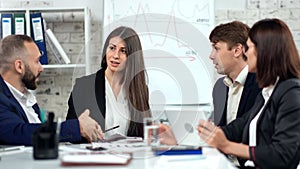 Smiling stylish business people having friendly communication at team meeting in modern office