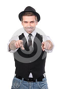 Smiling stylish caucasian man pointing his fingers at the camera