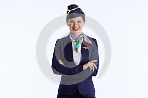 smiling stylish female air hostess on white