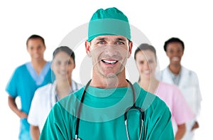 Smiling surgeon in front of his team