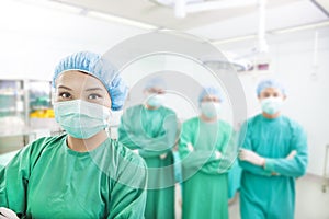 Smiling surgeon posing with aesthetic medicine teams