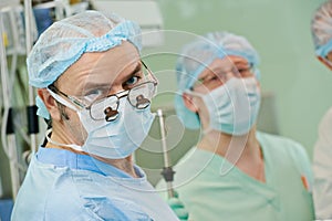 Smiling surgeons team at cardiac surgery operation
