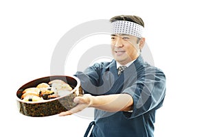 Smiling sushi chef