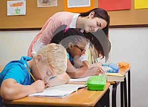 Smiling teacher helping a student