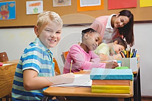 Smiling teacher helping a student