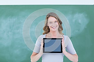 Smiling teacher holding tablet pc