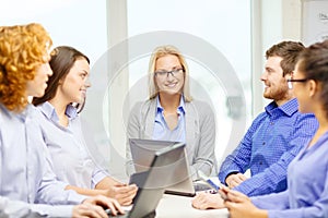 Smiling team with laptop and table pc computers