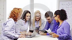 Smiling team with laptop and table pc computers