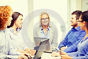 Smiling team with laptop and table pc computers