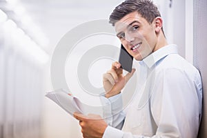 Smiling technician on the phone holding a document