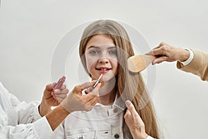 Smiling teen girl child have makeup done by older generations