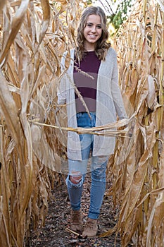 Smiling teen girl in cornfield