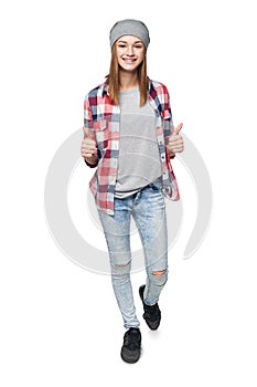 Smiling teen girl in full length giving double thumb up
