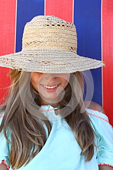 Smiling teen girl in hat on beach