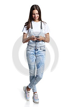 Smiling teen girl with smart phone in hands,