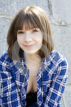 Smiling teen girl wearing chequered shirt