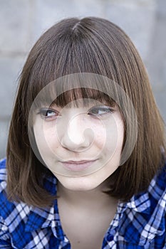 Smiling teen girl wearing chequered shirt