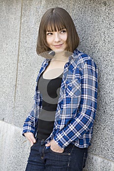 Smiling teen girl wearing chequered shirt