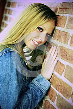 Smiling teen leaning on wall