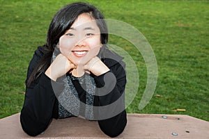Smiling Teen Resting Chin on Hands