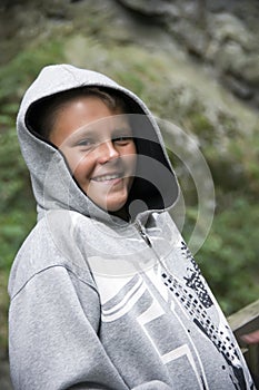 Smiling teenage boy in hood