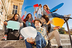 Smiling teenage boys and girls with speech bubbles