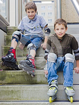 Smiling teenage boys in roller-blading protection kits