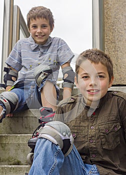 Smiling teenage boys in roller-blading protection kits photo