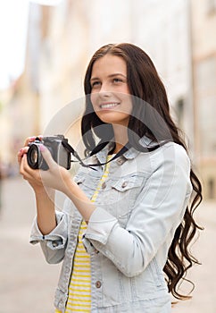 Smiling teenage girl with camera