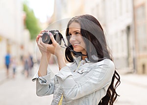 Smiling teenage girl with camera