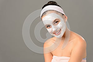 Smiling teenage girl cosmetics mask skin beauty