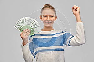 Smiling teenage girl with euro money banknotes