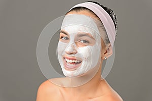 Smiling teenage girl face mask bare shoulders