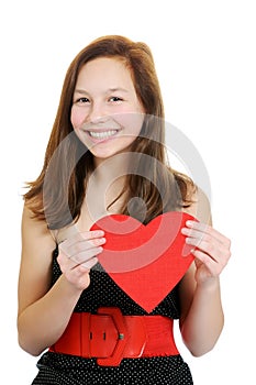 Smiling teenage girl holding valentine heart