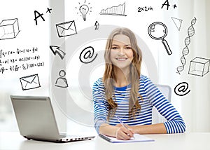 Smiling teenage girl laptop computer and notebook