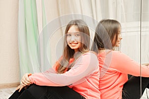 Smiling teenage girl at mirror