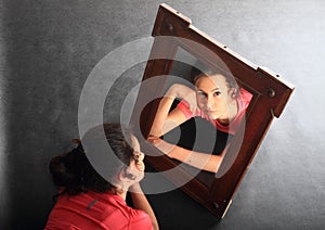 Smiling teenage girl mirroring in mirror