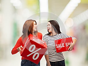 Smiling teenage girl with percent and sale sign