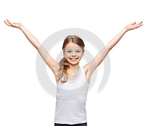 Smiling teenage girl with raised hands