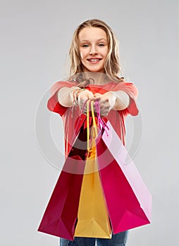 Smiling teenage girl with shopping bags