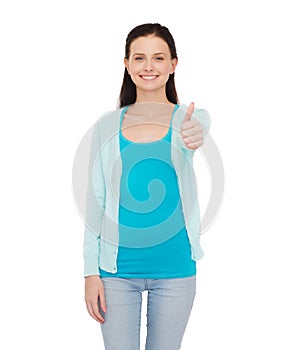 Smiling teenage girl showing thumbs up