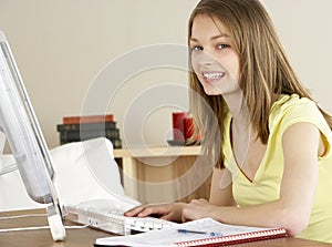 Smiling Teenage Girl Studying at Home