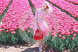 Smiling teenage girl walks through tulip field