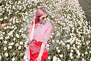 Smiling teenage girl walks through tulip field