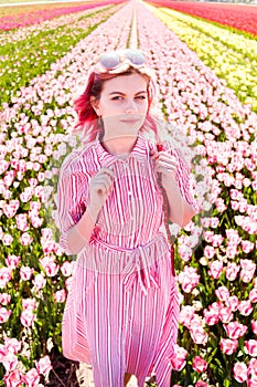 Smiling teenage girl walks through tulip field