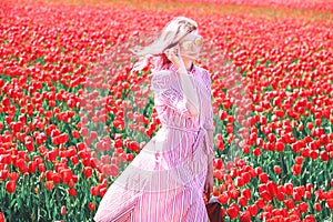 Smiling teenage girl walks through tulip field