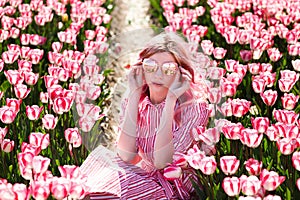 Smiling teenage girl walks through tulip field