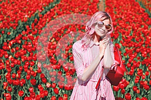 Smiling teenage girl walks through tulip field