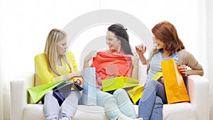 Smiling teenage girls with many shopping bags