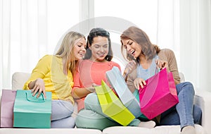 Smiling teenage girls with many shopping bags